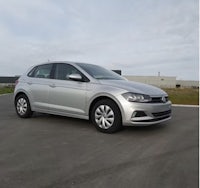 a silver volkswagen polo parked in a parking lot