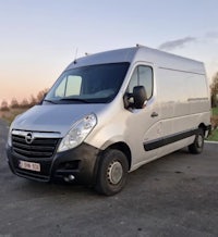 a silver van parked on the side of the road